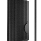 Left-hand opening black batten edge iron pivot entry door with a textured surface, set within a minimalist frame.