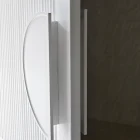 White iron batten entry door with a circular handle, showcasing sleek lines and a textured surface against a neutral background.